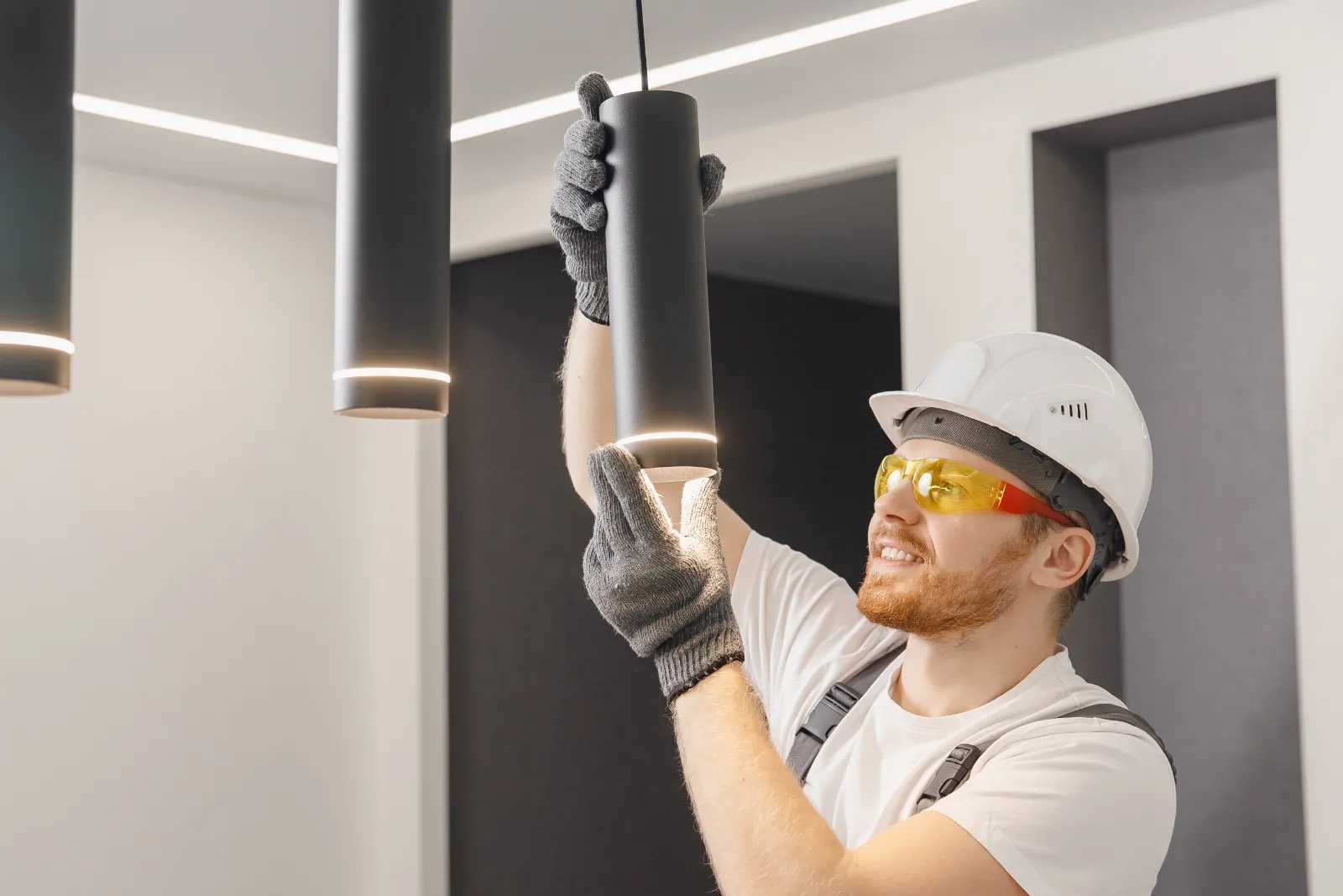 handyman installing lights in an office building